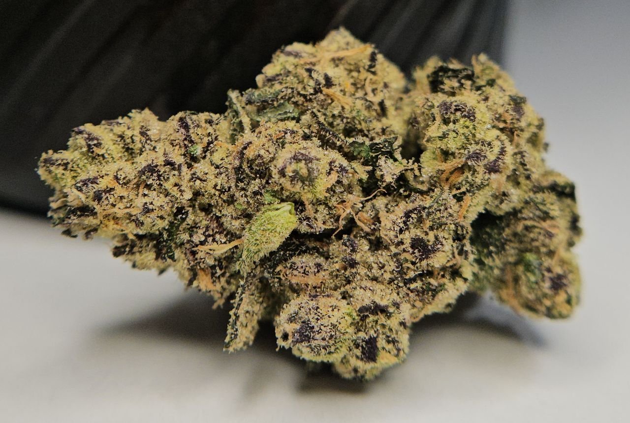 Macro detail of ZOURZ by HALL OF FLAME frosty cannabis nugs with purple accents