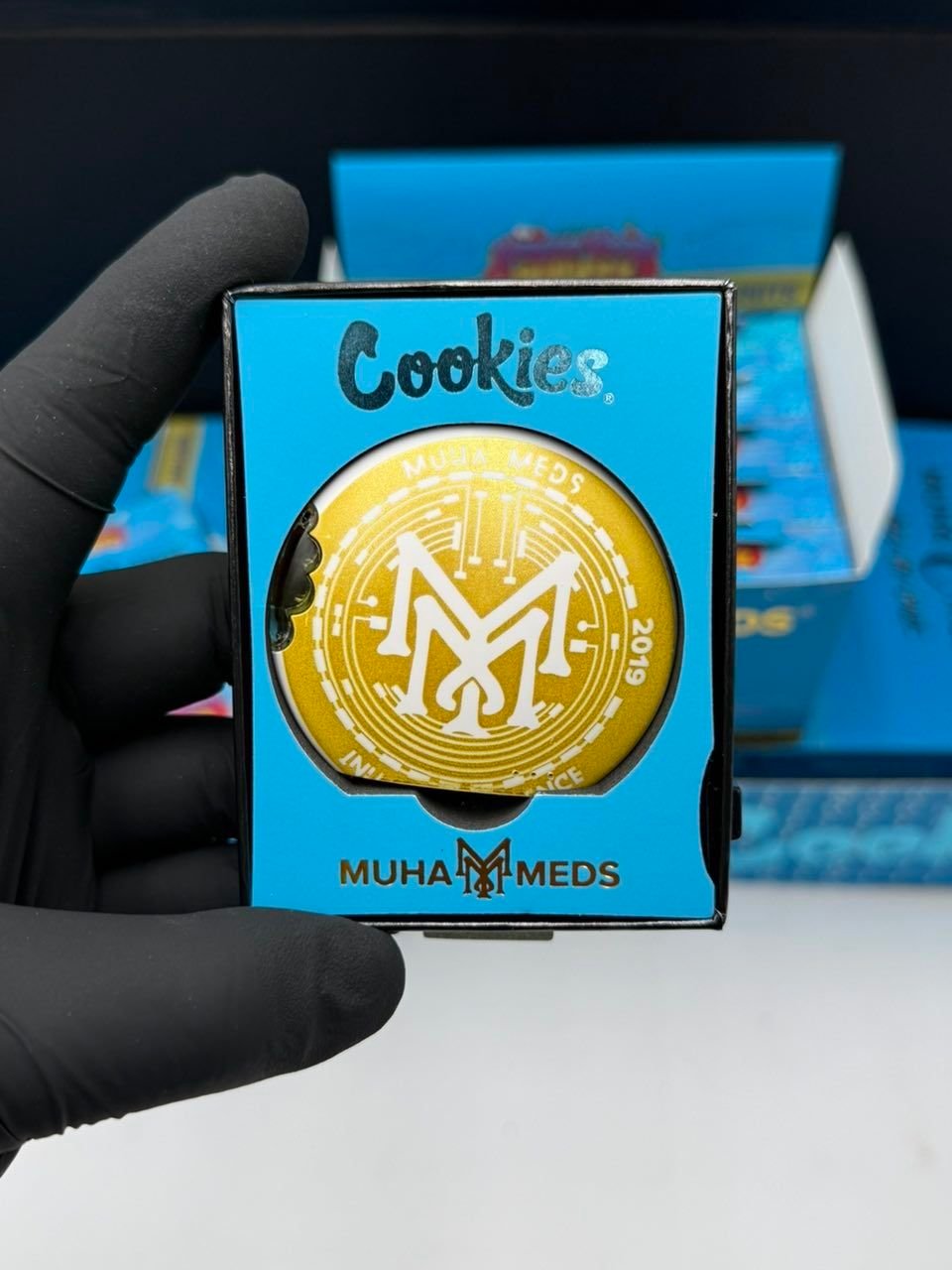 Cookies Muha Meds Vapes gold coin branding close up on blue box