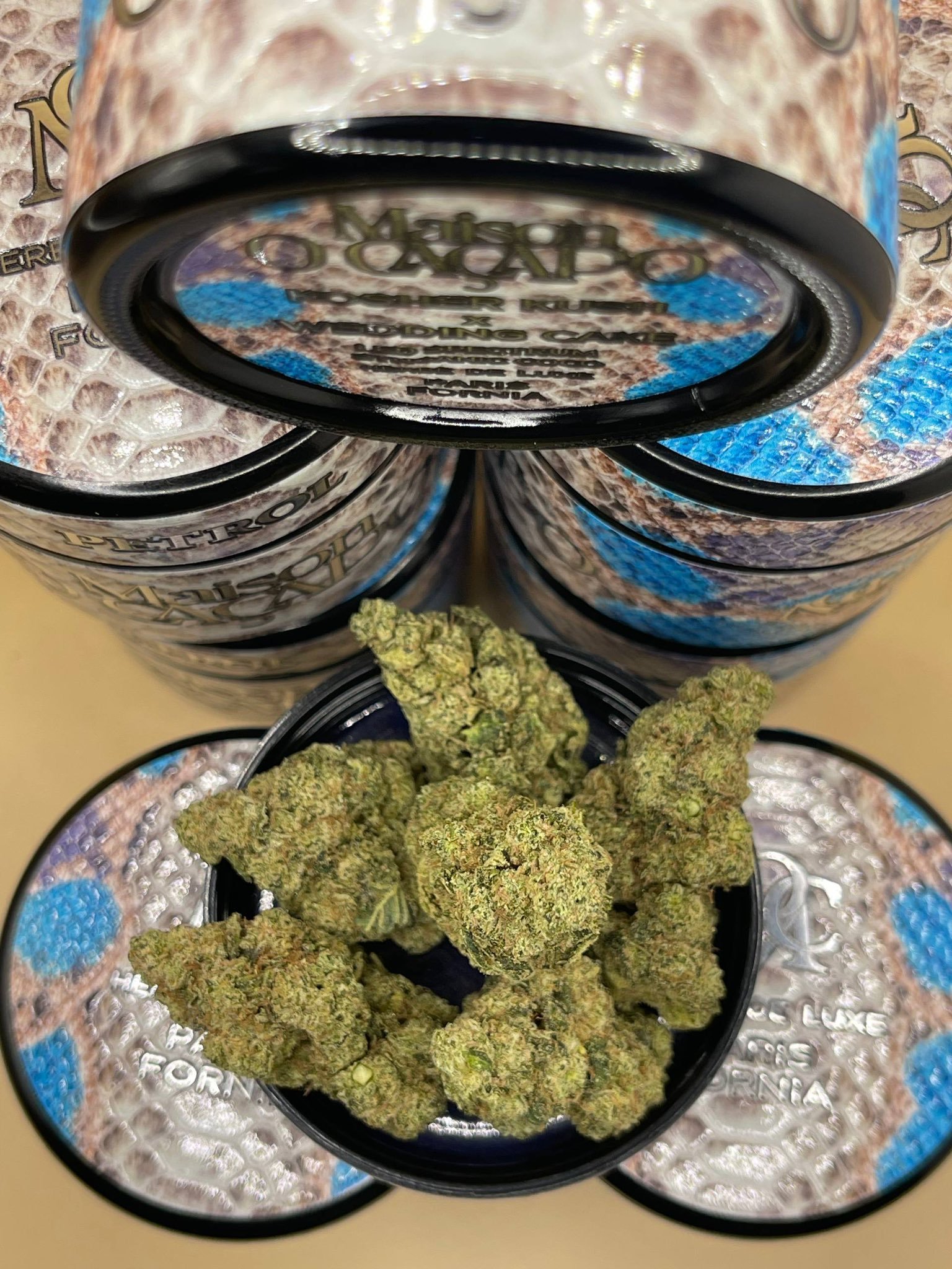 PETROL by MAISON O CACAPO cannabis buds in open jar with stacked designer jars in background