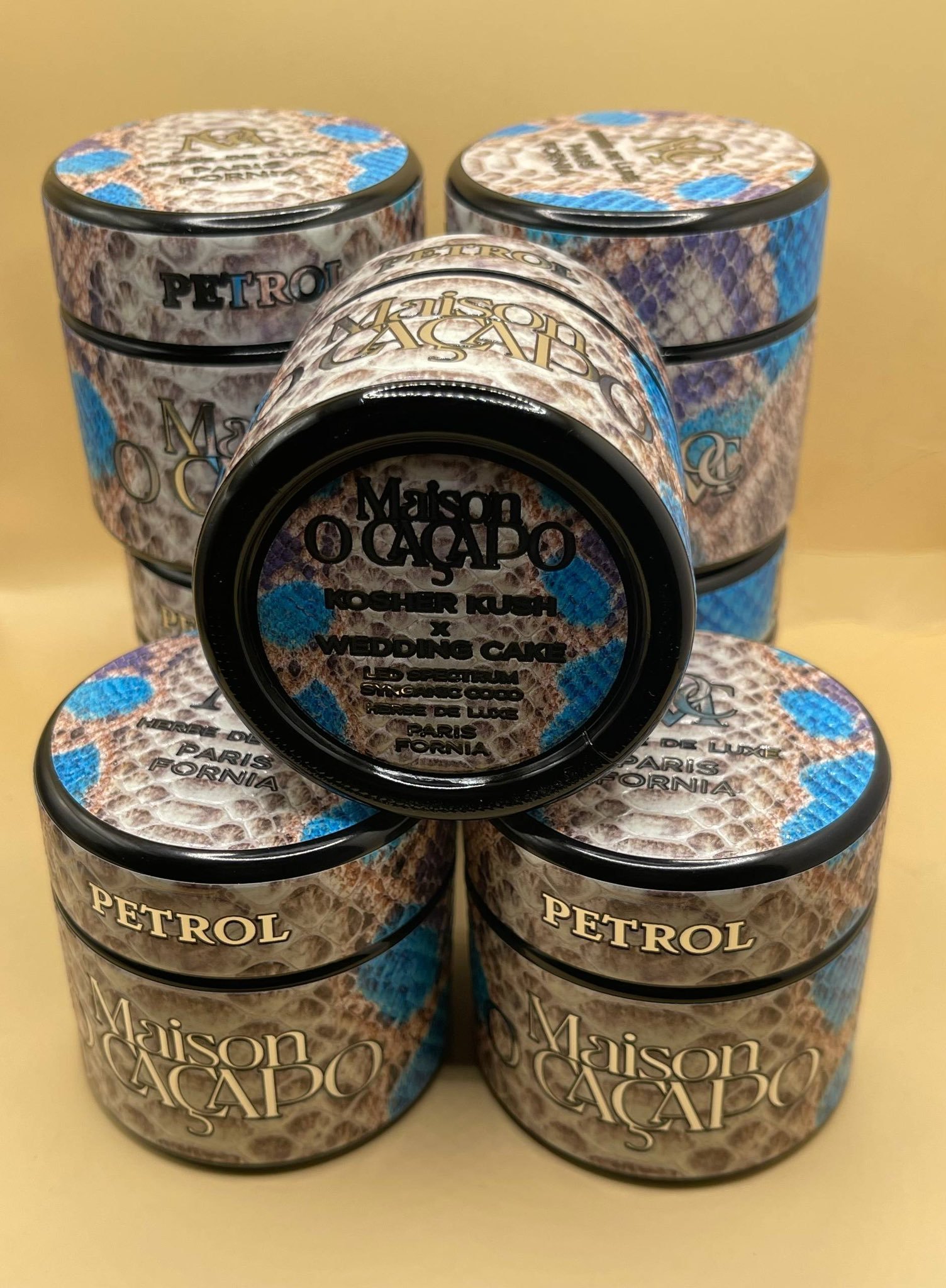 PETROL by MAISON O CACAPO luxury cannabis jars stacked with snakeskin design and blue accents showing premium packaging