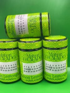 LEMON GIELA by MAISON O CACAPO luxury jars stacked with bright green Herbe De Luxe packaging and lemon candy gas strain buds