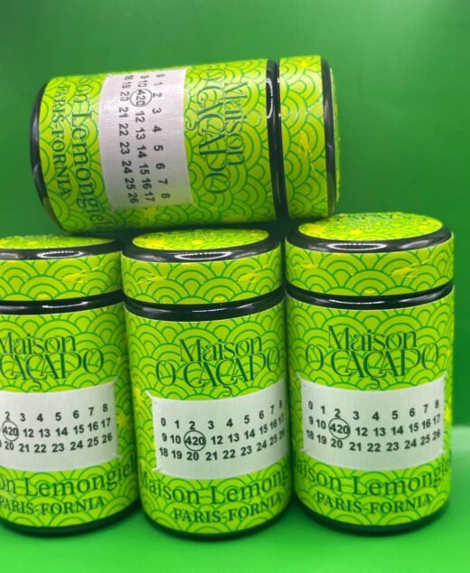 LEMON GIELA by MAISON O CACAPO luxury jars stacked with bright green Herbe De Luxe packaging and lemon candy gas strain buds