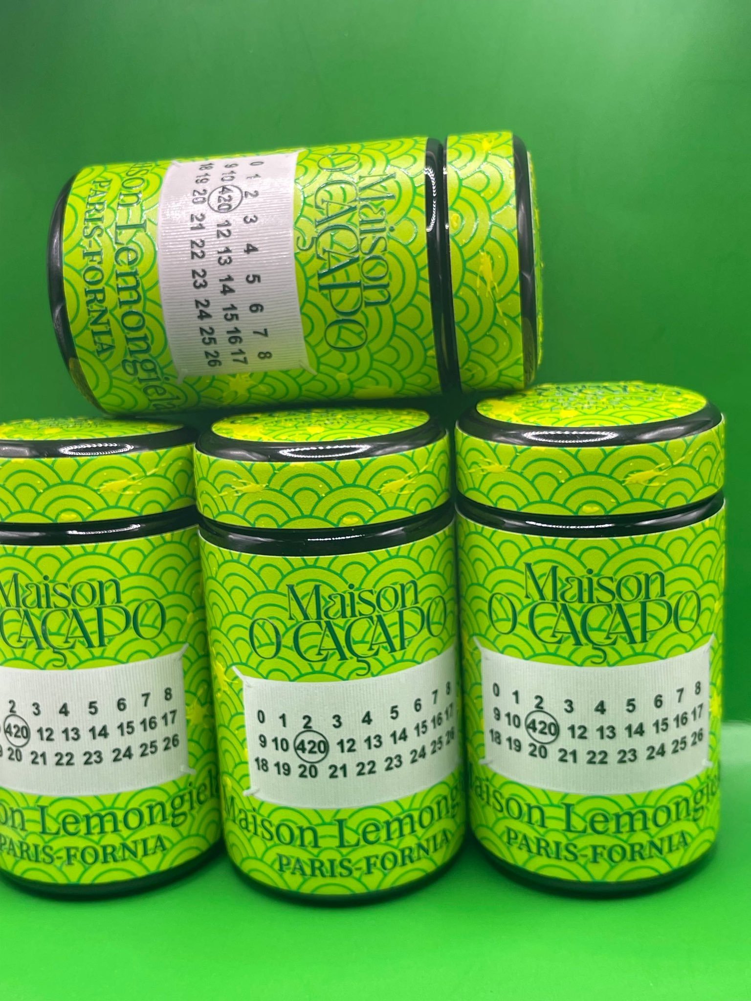LEMON GIELA by MAISON O CACAPO luxury jars stacked with bright green Herbe De Luxe packaging and lemon candy gas strain buds